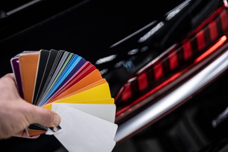 man choosing color of his car with color sampler